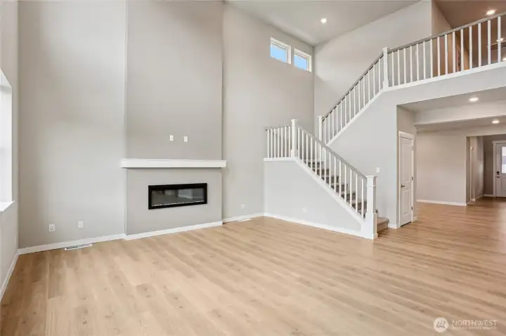 Modern electric fireplace feature wall is focal point of the open plan living area.