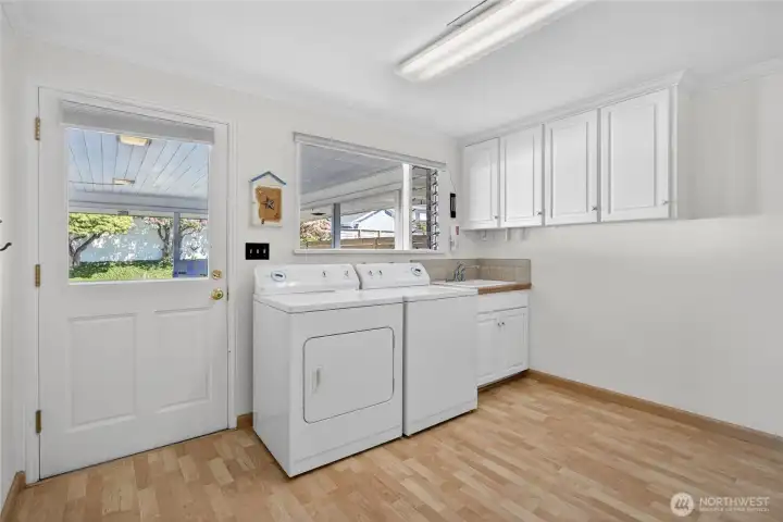 Laundry room off kitchen leading to carport and side yard
