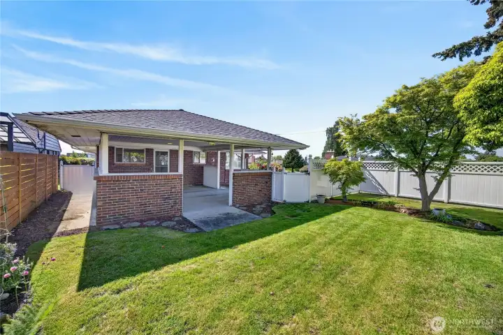 Side yard looking at attached carport