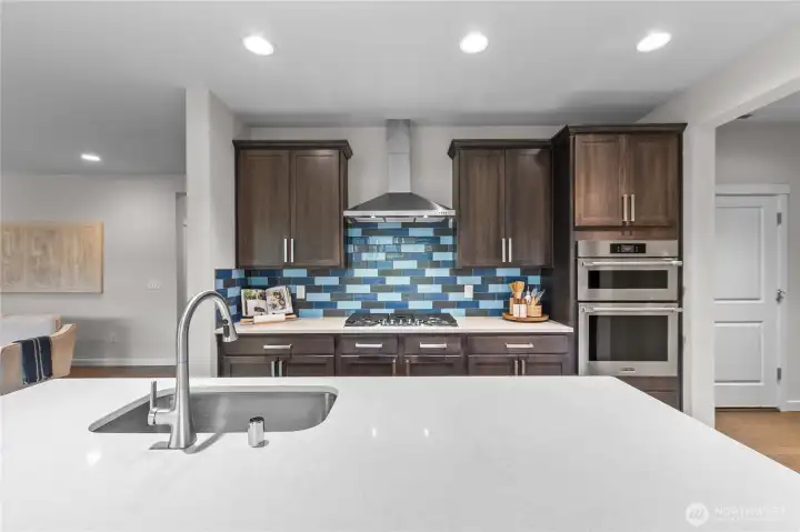 The spacious kitchen features a large island with generous seating for 4.