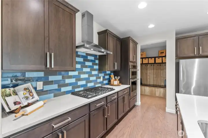 Kitchen acces to garage via mudroom and oversized walk-in pantry.