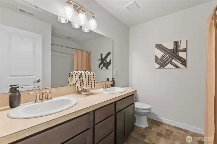 Hall bath with double vanity.