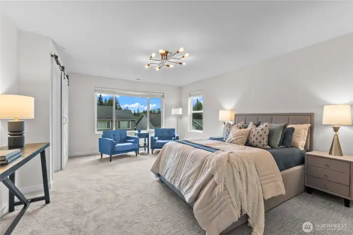 Expansive primary suite with sitting area and mountain views.