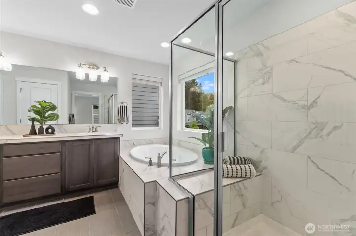 Large primary bathroom with soaker tub and walk-in shower.