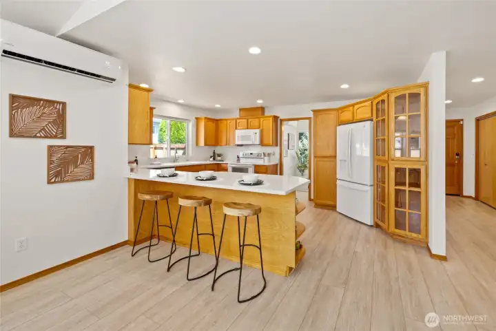 Quartz countertops and a spacious peninsula provide room for cooking and casual dining.