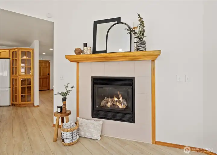 A cozy gas fireplace creates a warm focal point for gathering year-round.