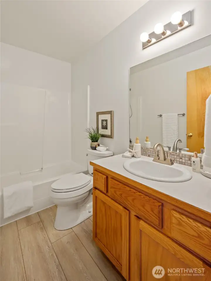 Main bath with fresh finishes and a full tub/shower combination.