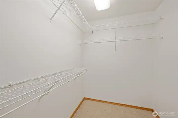 Generous walk-in closet offers storage and organization.
