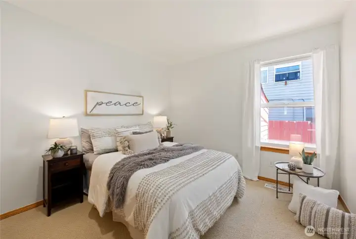 Peaceful bedroom offering warmth, comfort, and abundant natural light.