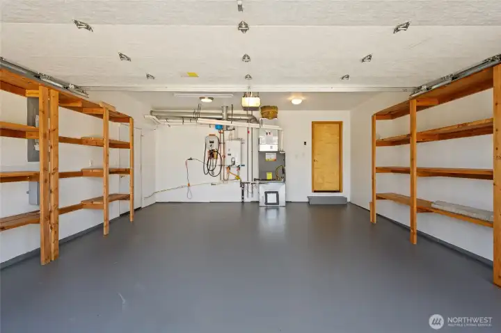 Finished garage with extensive built-in shelving, EV charging, and exceptional storage.