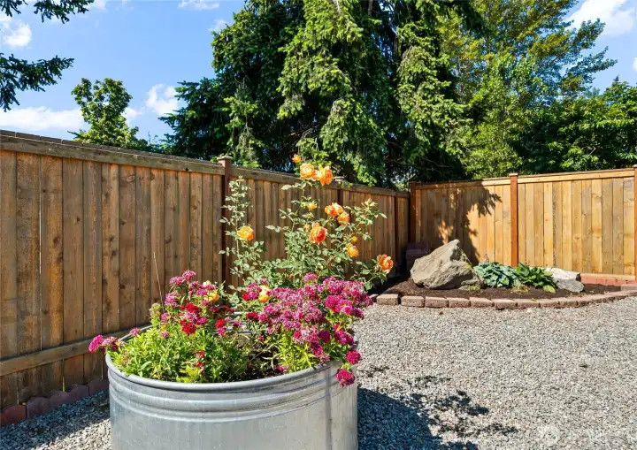 The fully fenced backyard is designed for relaxing, gardening, and enjoying the outdoors.