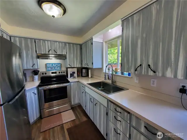 Galley kitchen with brand new massive sink.