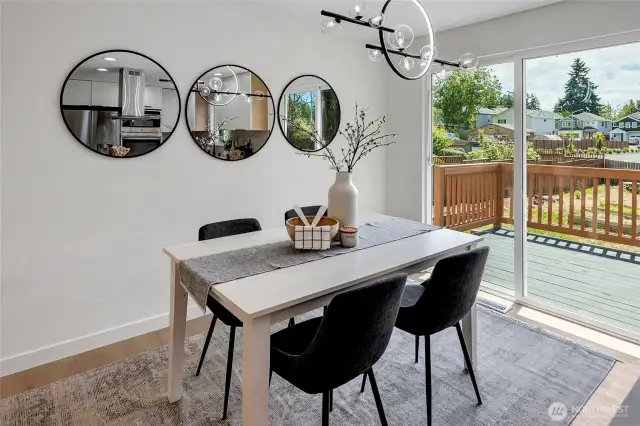 Dining room with slider that opens to large deck.
