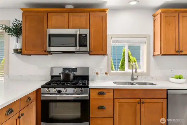 Quartz countertops and stainless steel appliances.