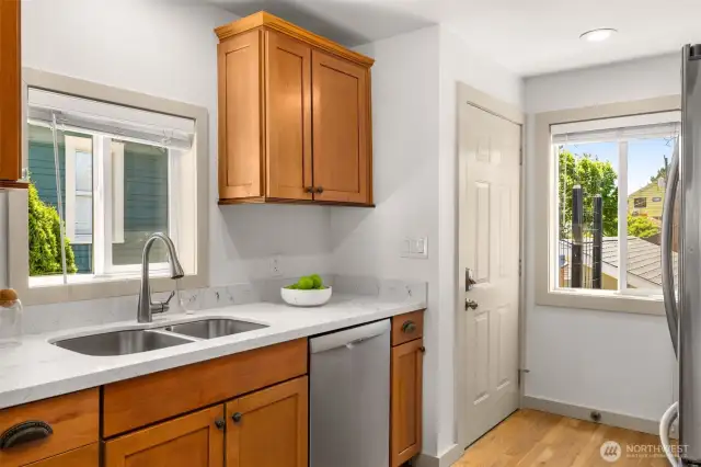Quartz countertops and stainless steel appliances.Door leads to the deck with the hot tub.