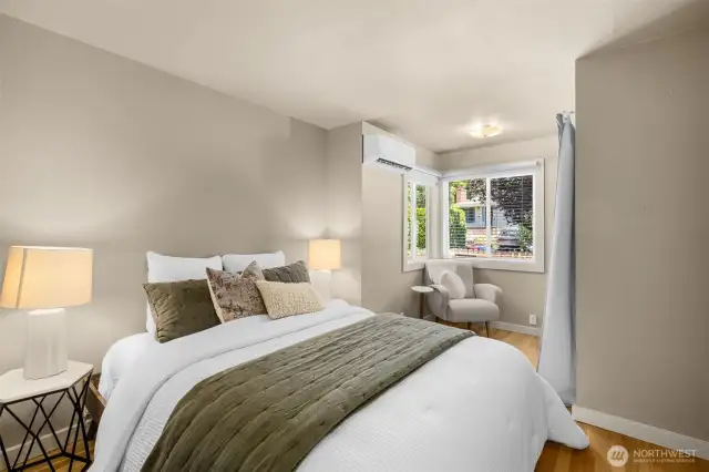 Primary bedroom features a minisplit, closet and hardwood floors.