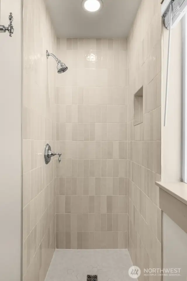 Main level bathroom was beautifully remodeled in 2025 with new ceramic tile and updated plumbing.