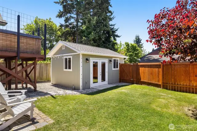 Fully fenced-in backyard includes a new detached garage, hot tub and pavers.