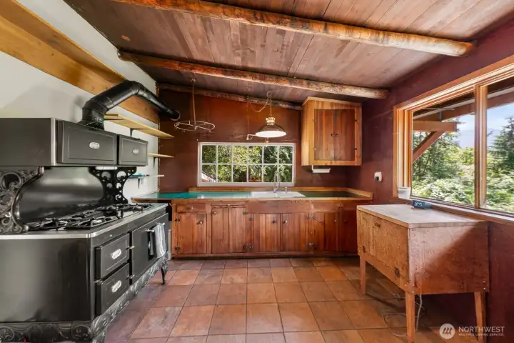 Kitchen with a large vintage range that adds to the charm.