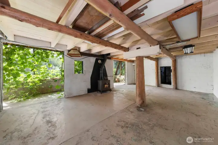 Wood burning fireplace in the basement by the atrium/greenhouse.