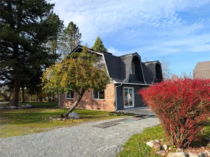 Apples are abundant. Back of the home with patio & deck off the kitchen & living areas.