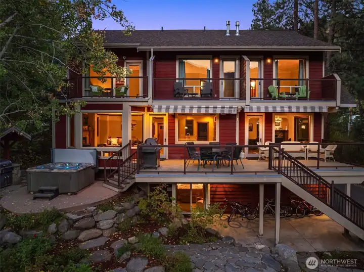 Expansive multi-level outdoor living with elevated decks, hot tub, and covered patio—perfectly designed for entertaining and enjoying this private riverfront retreat.