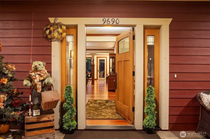 Inviting entry with warm wood accents and sidelights, opening to a welcoming interior that immediately showcases the home’s craftsmanship and charm.