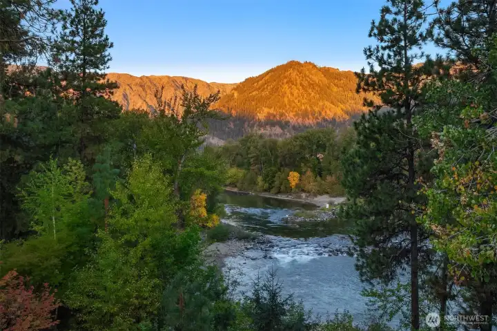 Wake up to breathtaking alpenglow as the surrounding mountains light up above the Wenatchee River, creating a truly unforgettable morning view.