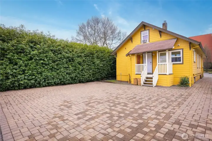 The backside of the office porch includes a durable Trex® deck, complemented by mature privacy shrubs that fully line and screen the north property boundary.