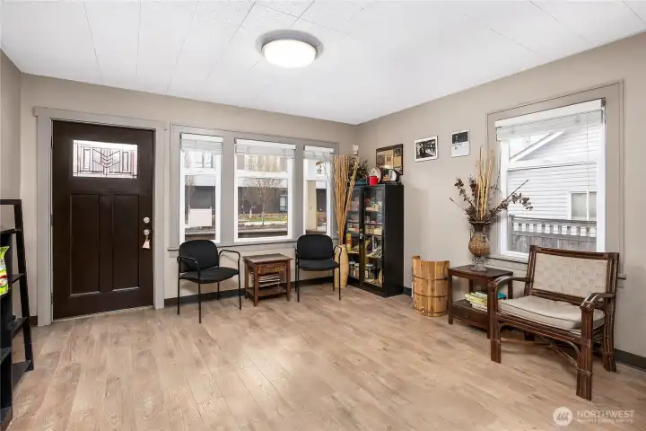 Bright front lobby filled with natural light from multiple windows.