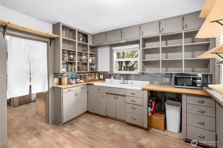 Well-appointed kitchen with hardwood floors and ample shelving for all your storage needs. Stove to be installed prior to appraisal.