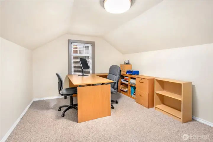 Versatile upper-level space ideal as an office or third bedroom, complete with newer carpet, updated lighting, vinyl windows, and A/C to keep the room cool on warm summer days.