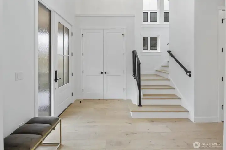 Bright, airy entry with clean-lined staircase details and an immediate sense of openness from the moment you step inside.