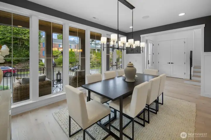 Dining space is framed by expansive windows and natural light, creating an inviting setting for both everyday meals and elevated entertaining.