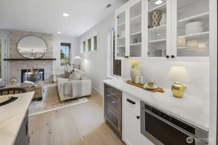 Built-in cabinetry and beverage storage add polish and practicality, creating a sophisticated extension of the kitchen and gathering spaces.