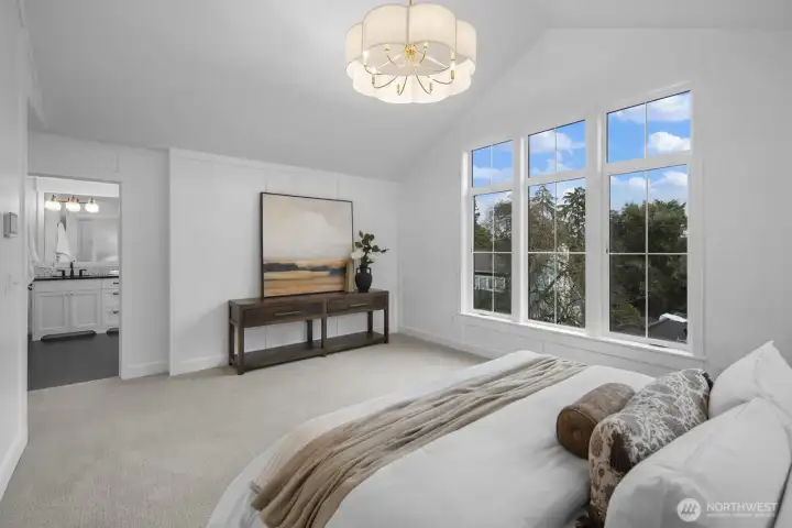 Another view of the primary suite showcases its generous proportions and easy connection to the spa-inspired bath beyond.