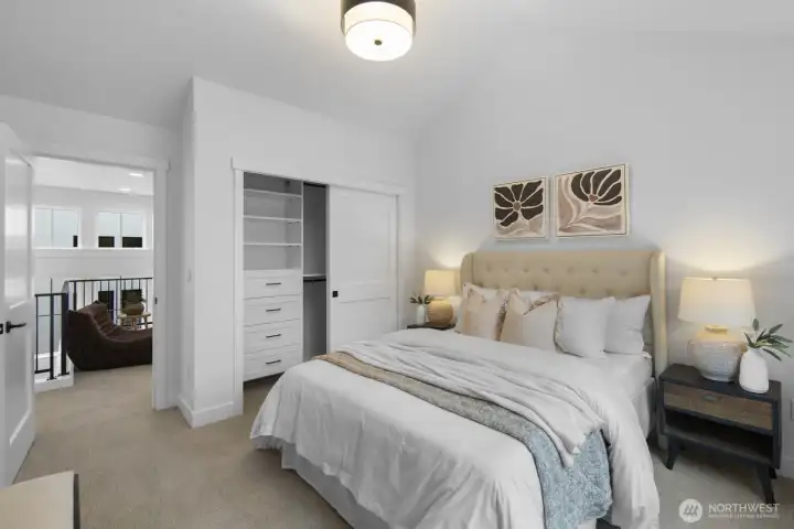 Bright and comfortable, this upper-level bedroom offers generous proportions, soft natural light, and easy access to the surrounding hallway spaces.