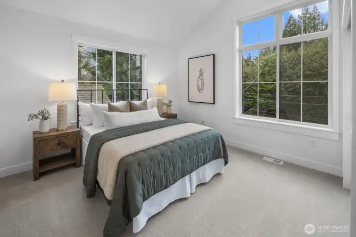 A second secondary bedroom feels equally inviting, with large windows and a calm, airy atmosphere that works beautifully for guests or everyday living.