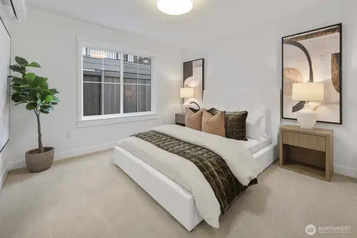 Bright and inviting, the lower-level bedroom offers a comfortable private retreat for guests, extended stays, or flexible everyday use.