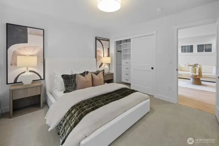 A second view of the lower-level bedroom highlights its clean design, generous proportions, and easy connection to the surrounding guest spaces.