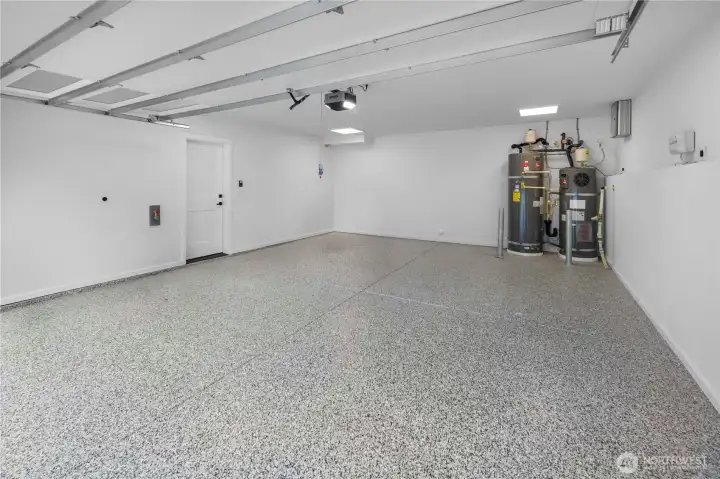 The attached two-car garage offers substantial room for parking, storage, and everyday practicality, with EV-ready capability adding modern convenience.