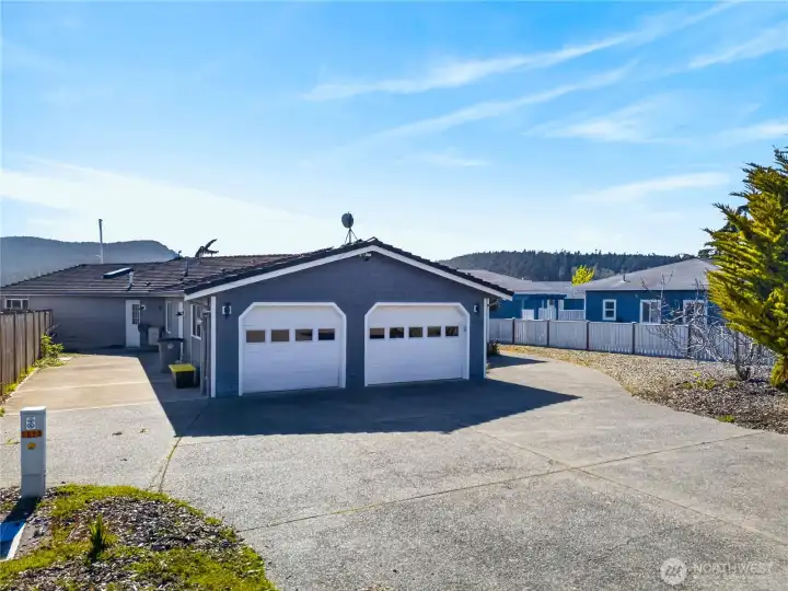 Spacious driveway and oversized two-car garage offer ample parking and storage, all set in a clean, low-maintenance setting with room for additional vehicles or recreational toys.