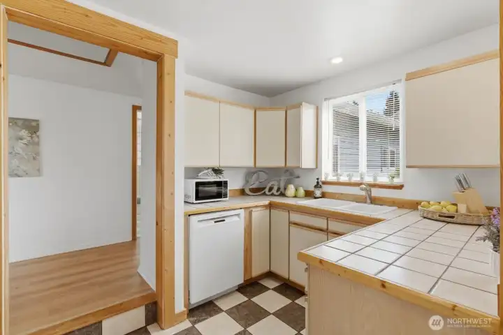 Cozy kitchen open to dining and view to the side patio