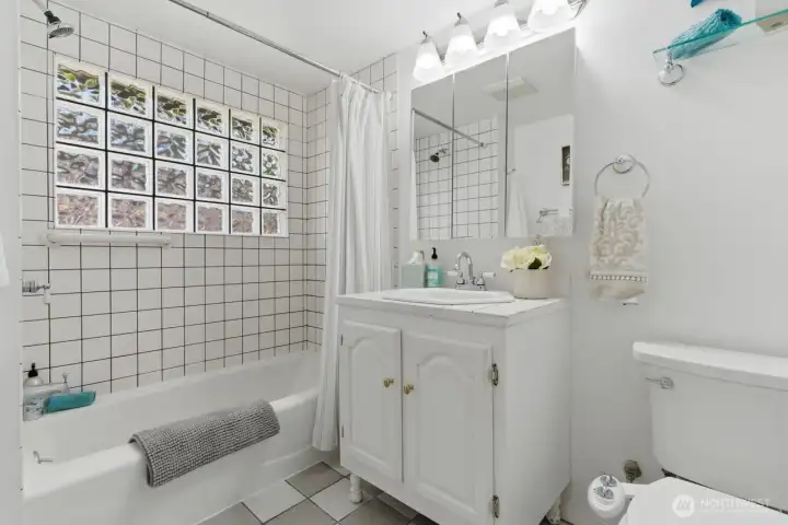 Full bath with natural light and built in linen closet