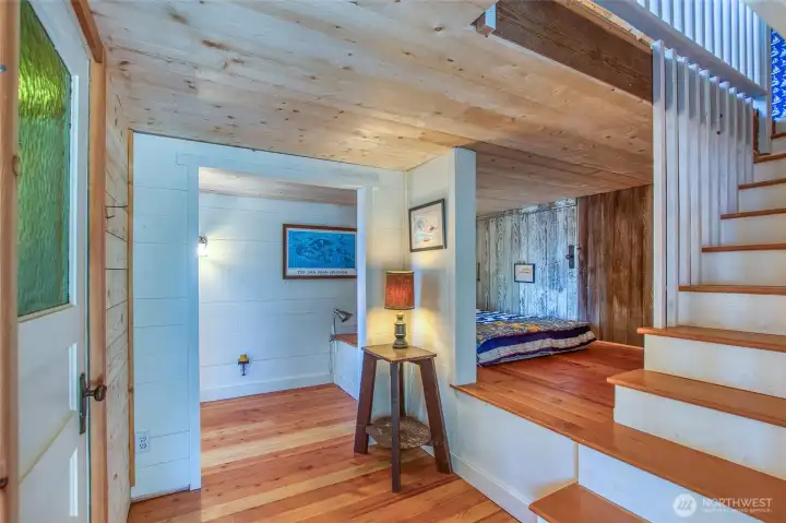Second studio structure  with sleeping platform and 3/4 bath on the lower level. Kitchenette and great room is upstairs to the right.