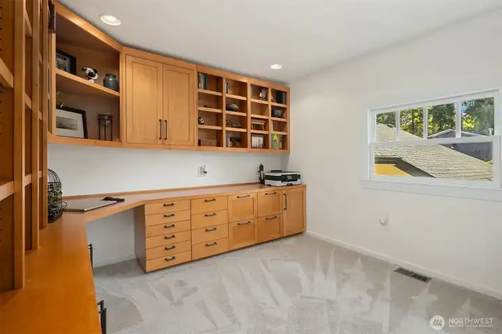 Currently used as an office, this upstairs bedroom features custom built-ins.