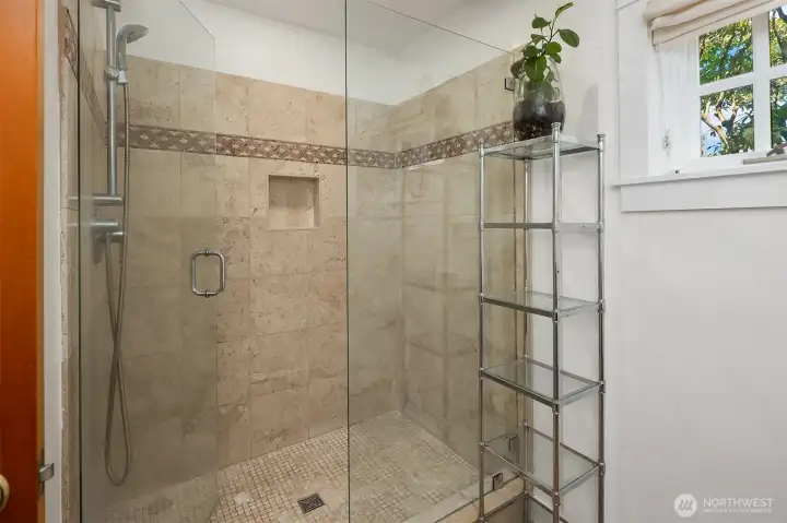 Spacious walk-in tile shower.
