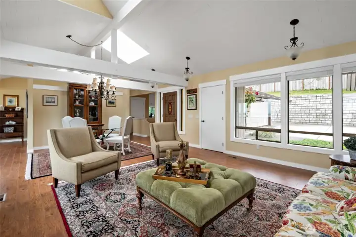 Living room with exposed beams and skylights.