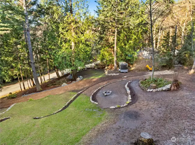 A rock fire pit sits in the center of the lot. Put your lawn chairs there and contemplate your vision for the site.