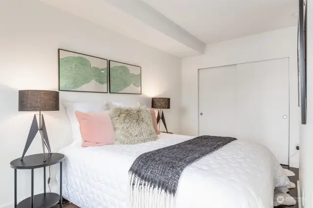 Cozy bedroom with large closet and custom  shelving system.